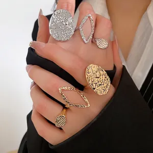 Lava textured gold and silver ring set featuring oval and rhombus geometric designs