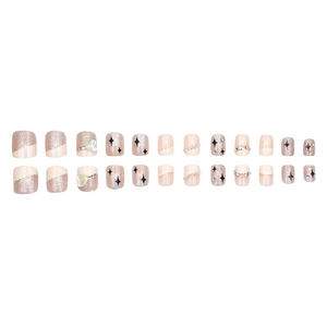 Elegant press-on nails set in creamy pink with rose gold glitter, stars, and pearls