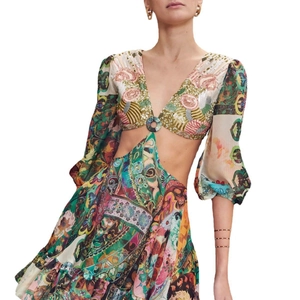 Detail of bohemian dress with waist cut-outs, metal ring connector, and sequins