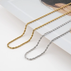 Close-up of twisted rope chain necklaces in gold and silver finish with metallic shine
