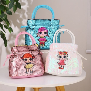 Detailed view of three sequin drawstring handbags with cute embroidered cartoon dolls