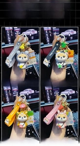 Close-up of four Shiba Inu zodiac keychains with colorful silicone straps and bells