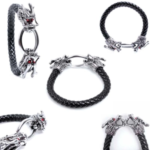 Detailed view of black braided leather bracelet with silver dragon head and red eyes