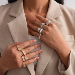 Close-up of luxury gold and silver rings with zircons on model hands for a chic look