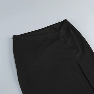 Detail shot of the waistband and invisible zipper on the black split maxi skirt