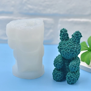 White silicone rabbit rose mold with a finished green textured candle for DIY baking