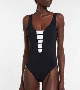 Detail of minimalist black one-piece swimsuit with white multi-strap cutout design