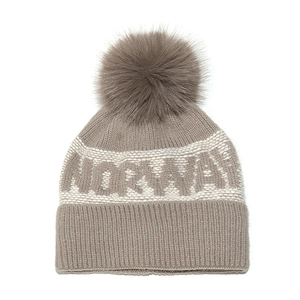 Detailed knit texture and soft faux fur pom-pom on the Norway jacquard beanie hat