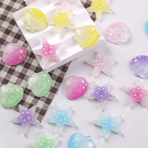 Close-up of colorful glittery resin starfish and seashells for DIY crafts and hair accessories
