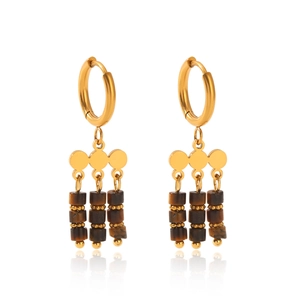 Macro detail of vintage tiger eye stone tassel earrings with gold circle pendants