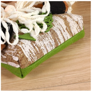 Detail of tree bark texture Christmas candy bag with green felt fabric and white stitching
