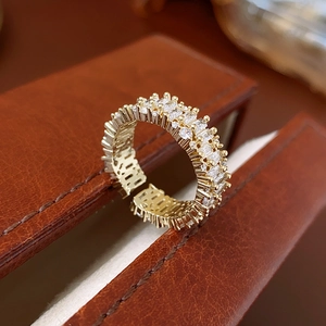 Detailed side view of adjustable gold ring featuring double row cubic zirconia crystals