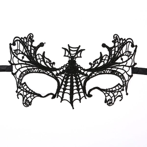 Detail of black lace masquerade mask with spider web embroidery and ribbon ties