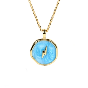 Detail of celestial gold pendant necklace with sky blue enamel and lightning bolt