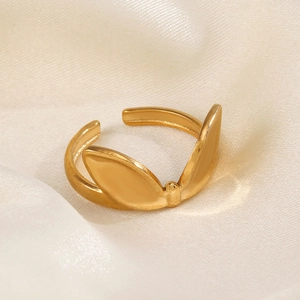 Polished gold rabbit ear stainless steel open ring on a soft silk background