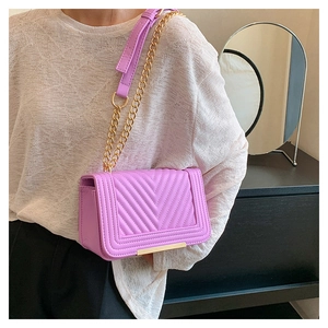 Close-up of lavender chevron quilted bag with golden chain strap and metallic trim
