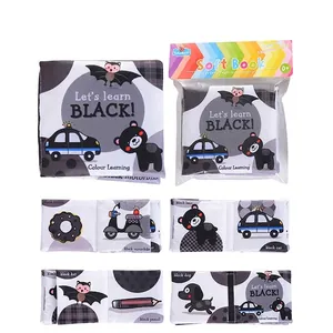 Detail of infant black and white soft cloth book in its packaging with animal inner pages