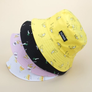 Stack of four colorful bucket hats in black, yellow, pink, and white with food prints