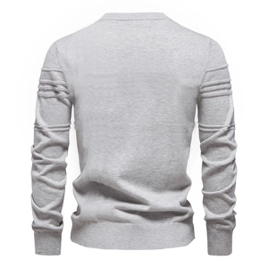 Rear view of light grey knit sweater with ribbed cuffs and upper arm texture details