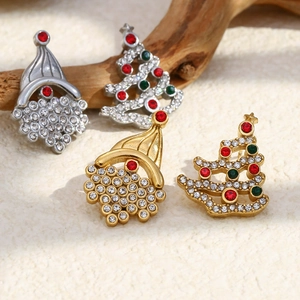 Detail of Christmas tree and hat stud earrings with colorful rhinestones on wood branch