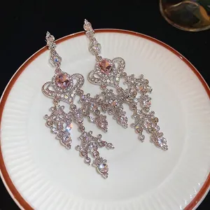 Sparkling silver drop earrings with pink oval stones and tassel rhinestones decoration