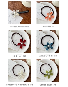 Detailed macro view of acetate floral hair ties and clips featuring elegant pearls