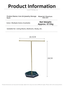 Detail of T-shaped jewelry stand with gold metal bar and green marble base 18.5x26cm