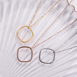 Close-up of three minimalist square geometric necklaces in gold, rose gold and silver