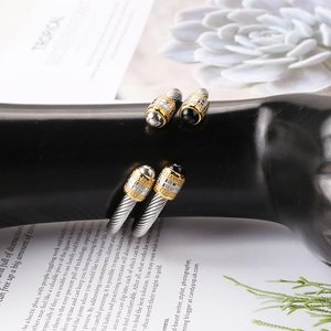 Detail of twisted cable stainless steel cuff with black onyx beads on a fashion model