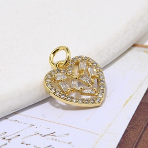 Golden heart pendant necklace with clear zircon stones on an elegant white background