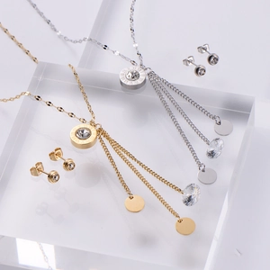 Macro detail of Roman numeral ring pendants and tassel charms on luxury jewelry set