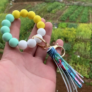 Colorful silicone bead bracelet keychain with mint green beads and blue leaf tassel
