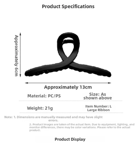 Detail view of large matte black ribbon hair claw clip showing size and PC material