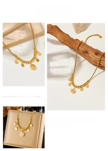 Detail of gold circle pendant necklace with sparkling rhinestone and snake chain