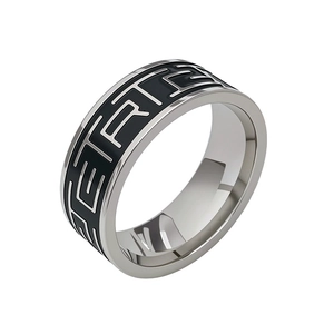 Macro view of vintage titanium steel ring with black geometric enamel pattern and silver finish