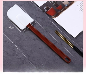 Detailed view of 14 inch silicone spatula with white blade and red handle for baking