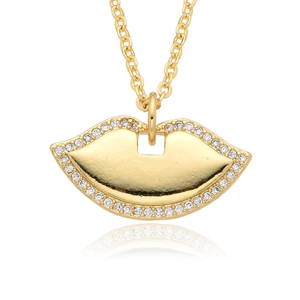 Detailed close-up of golden lip pendant with sparkling white zircon inlay on white background
