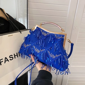 Detailed close-up of Royal blue sequined evening bag with fringe and golden handle