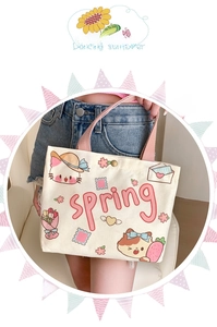 Detail of canvas tote bag with pink handles and cute cartoon animal illustrations