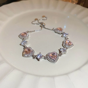 Detail view of pink heart-shaped crystal bracelet with adjustable silver sliding clasp