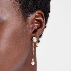 Detail of silver drop earring with tennis racket stud and hanging white pearl