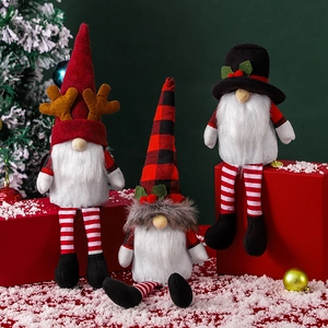 Three festive Christmas faceless gnomes with reindeer horns on gift boxes