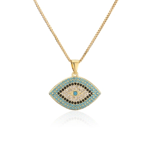 Close-up of gold evil eye pendant necklace with pavé zircon stones and box chain