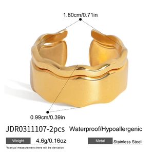 Detail of 18K gold plated stainless steel rings set showing irregular wave patterns