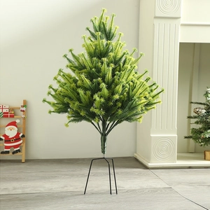 Close-up of a mini flocked Christmas tree with dense green needles and black metal stand