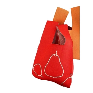 Red knitted tote bag with white pear pattern and orange straps for casual use