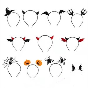 Flat lay of multiple Halloween headbands with devil horns, pumpkin, and bat wing designs