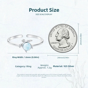 Size comparison of 925 silver turtle ring with blue stone against a US quarter coin
