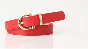 Detail view of red slim belt featuring a gold horseshoe buckle and fine stitching