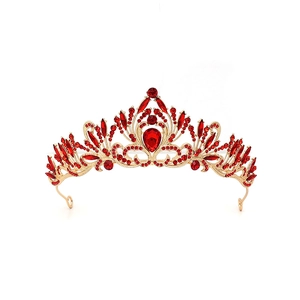 Detailed macro view of baroque gold tiara with red crystals and intricate metalwork